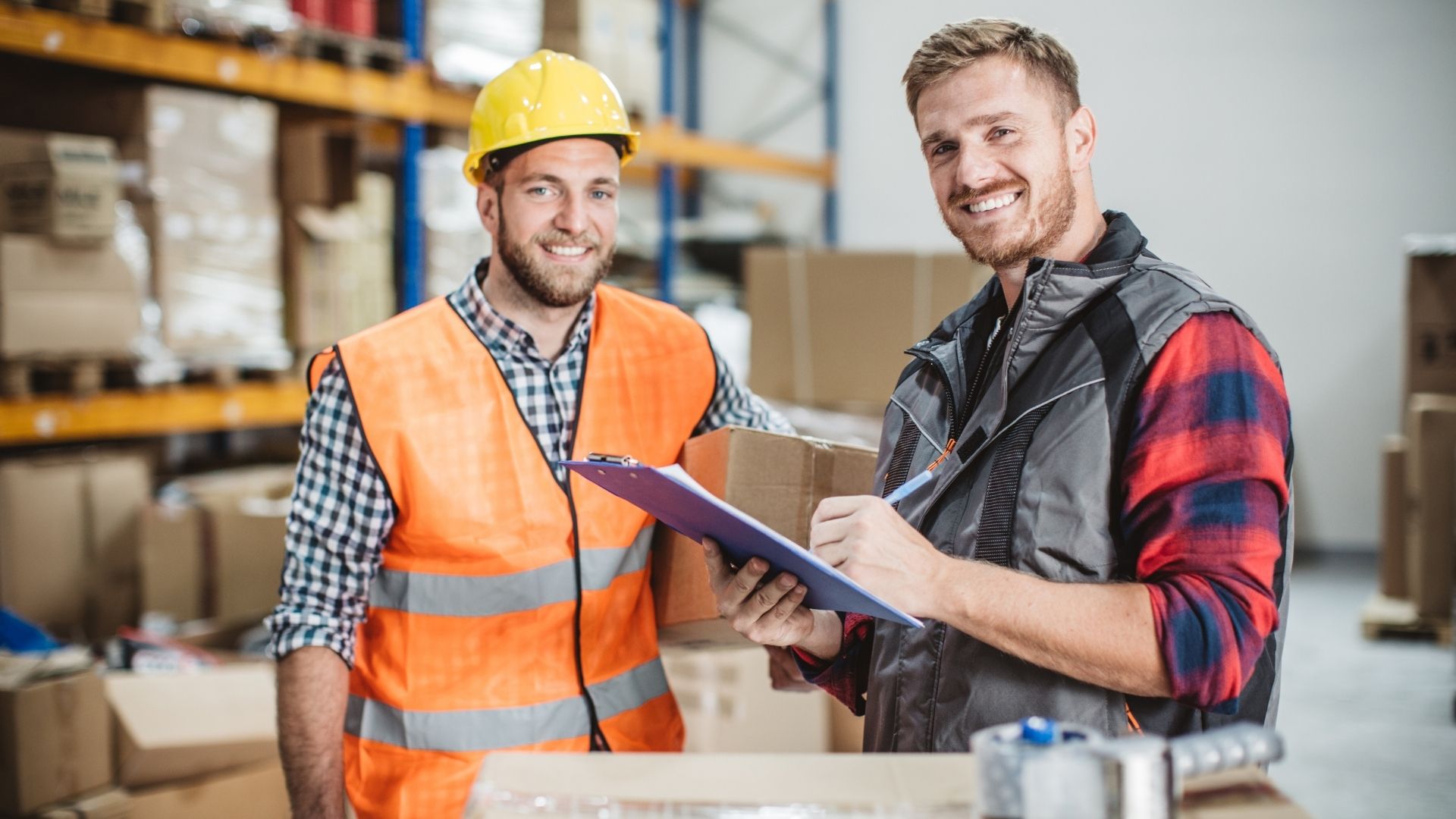 Workers in hi-vis vests reviewing training notes